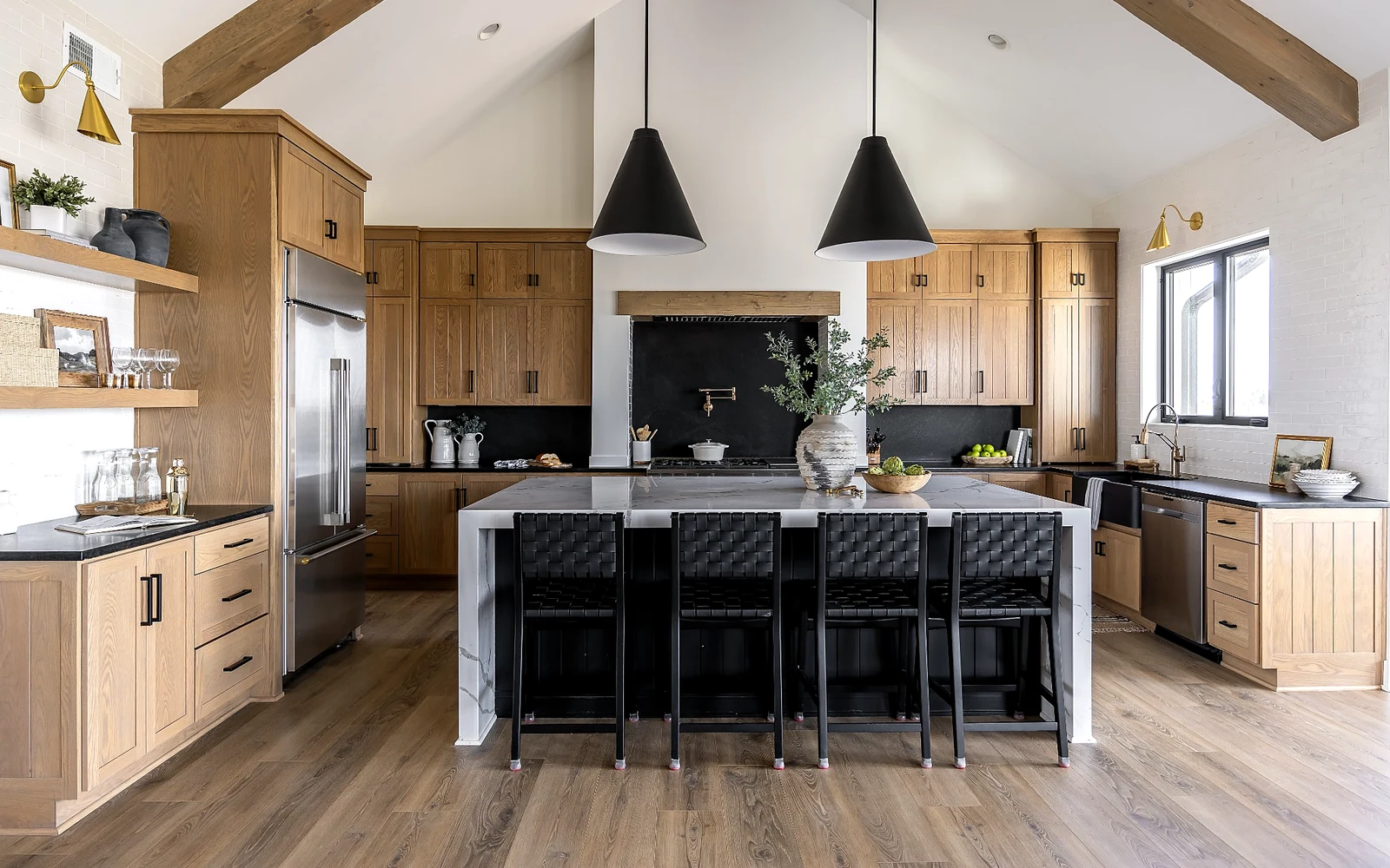 Open kitchen with wide pathways, wood-look flooring, island seating, and refined accessible luxury design